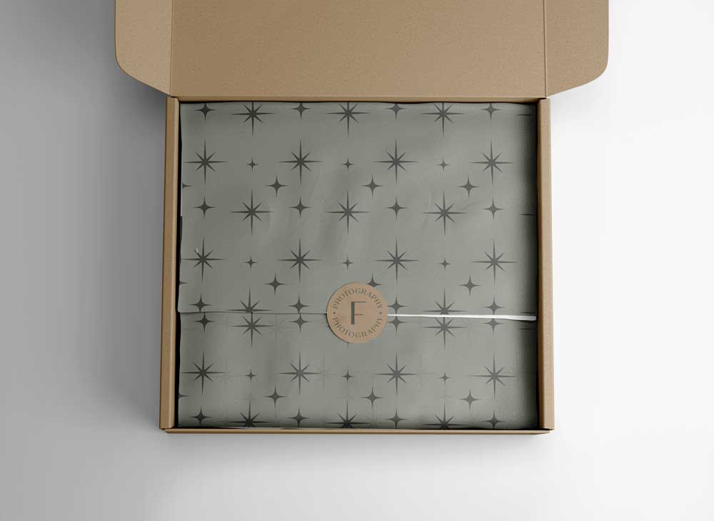 Fanlo's Photos Branding Pattern with stars and an earthy tone on tissue paper in a brown box